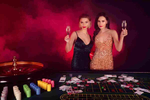 Poker chips and playing cards spread out on a green table.